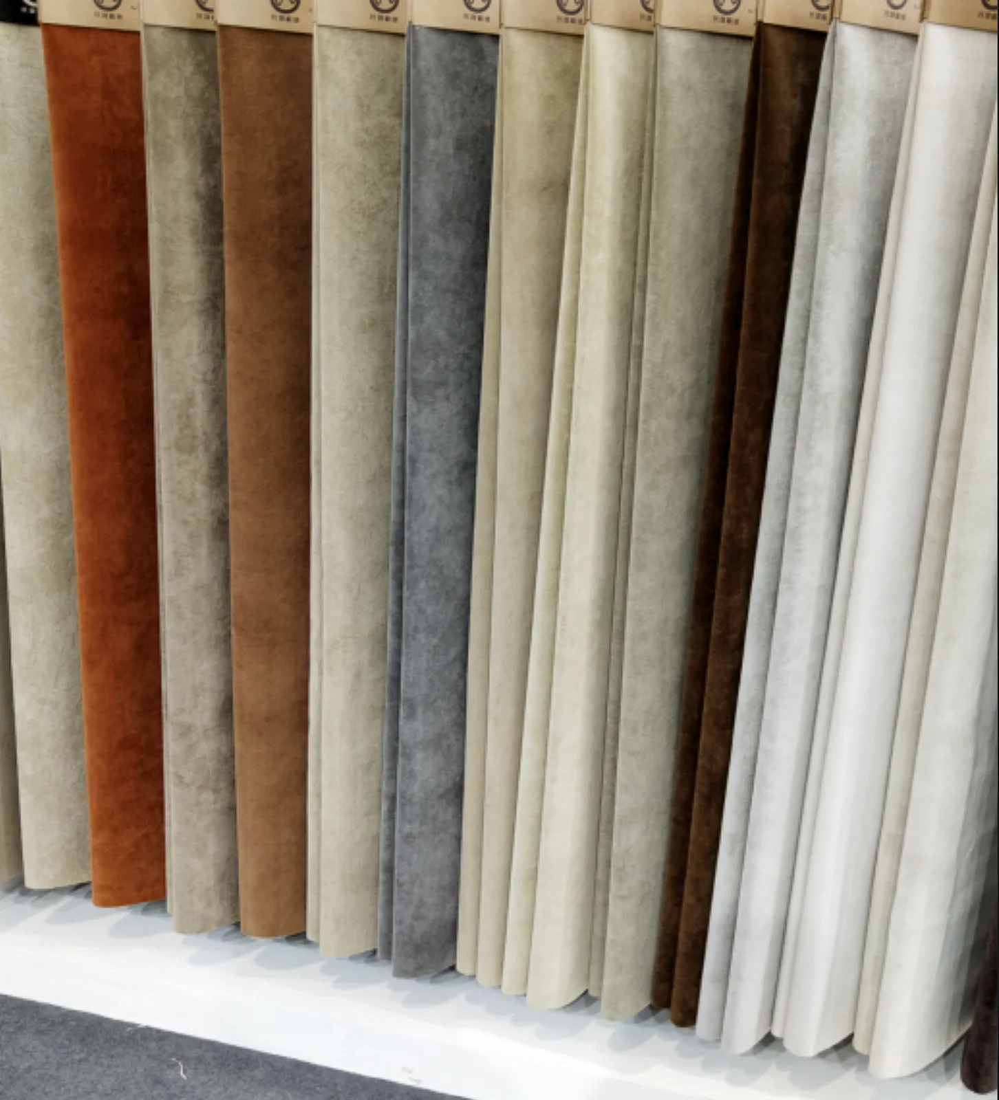 A range of Minsheng flocking fabrics in rust, grey, cream and brown